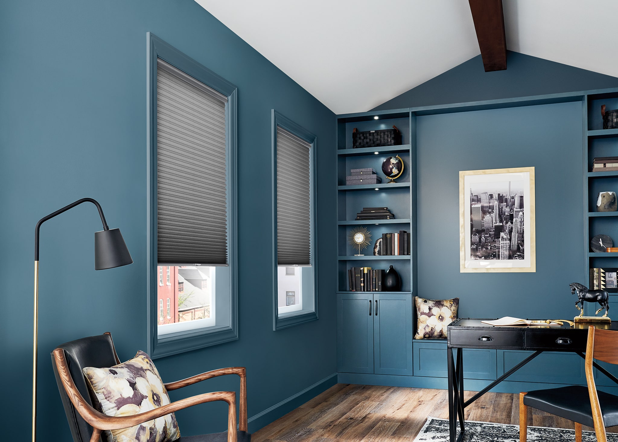 Honeycomb shades in a blue painted office space.